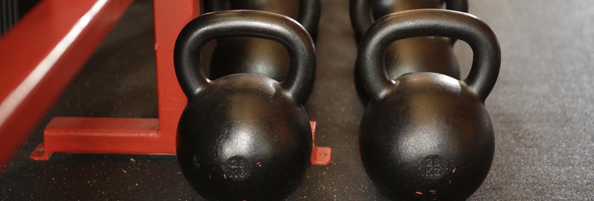 closeup of kettle bells on gym mat floor