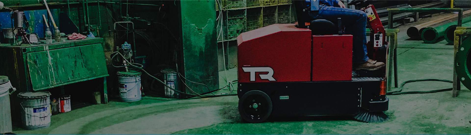 factory cat industrial floor sweeper being used in a machine shop