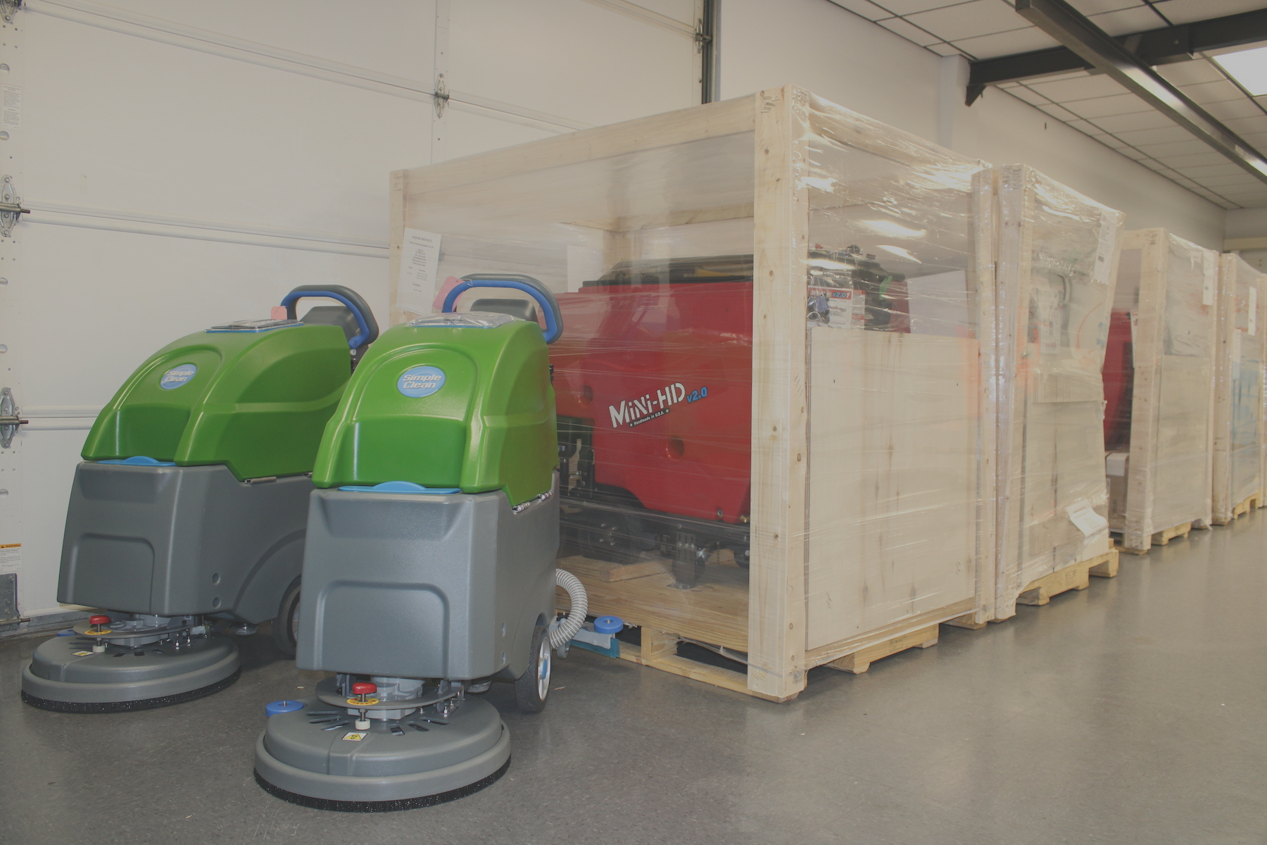 commercial floor scrubbers lined up in warehouse ready to ship