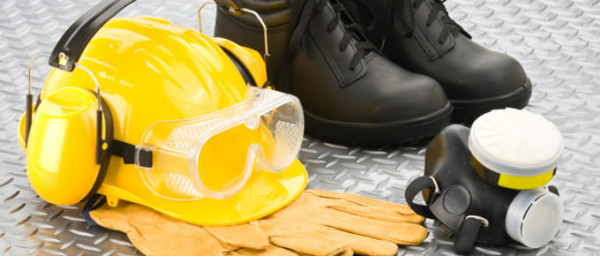 personal protective equipment on floor including hard hat safety goggles and boots