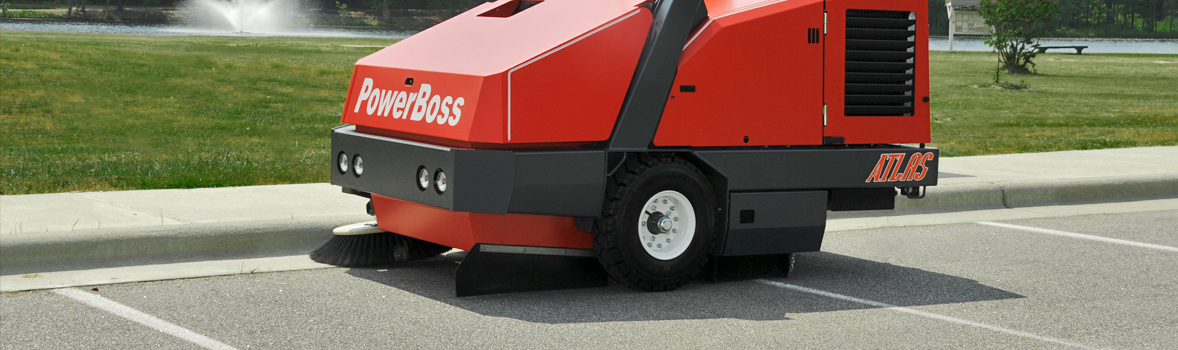 PowerBoss Atlas sweeping along the curb in a parking lot