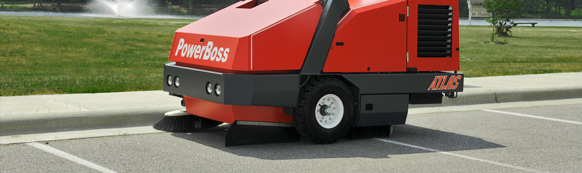 PowerBoss Atlas sweeping along the curb in a parking lot