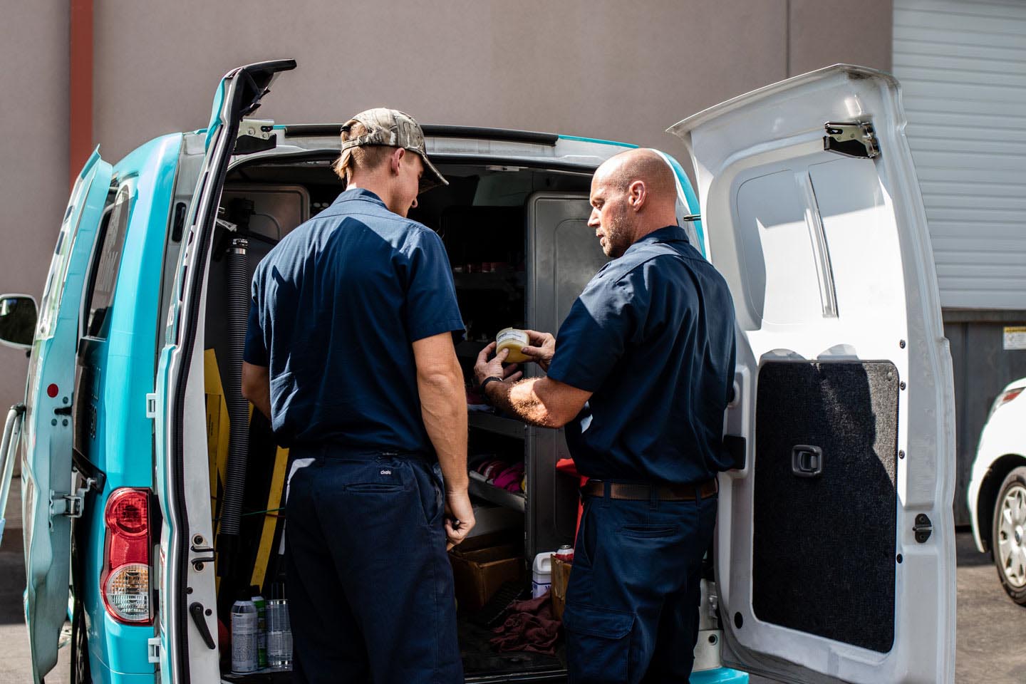 floor scrubber service technicians discussing repair