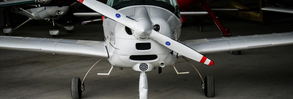 closeup of single engine propeller plane in hangar