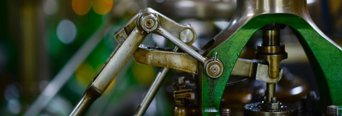 closeup of green metal manufacturing equipment