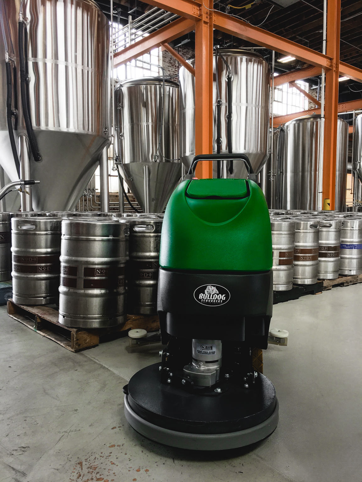 Bulldog WD20 in front of brewery equipment and kegs
