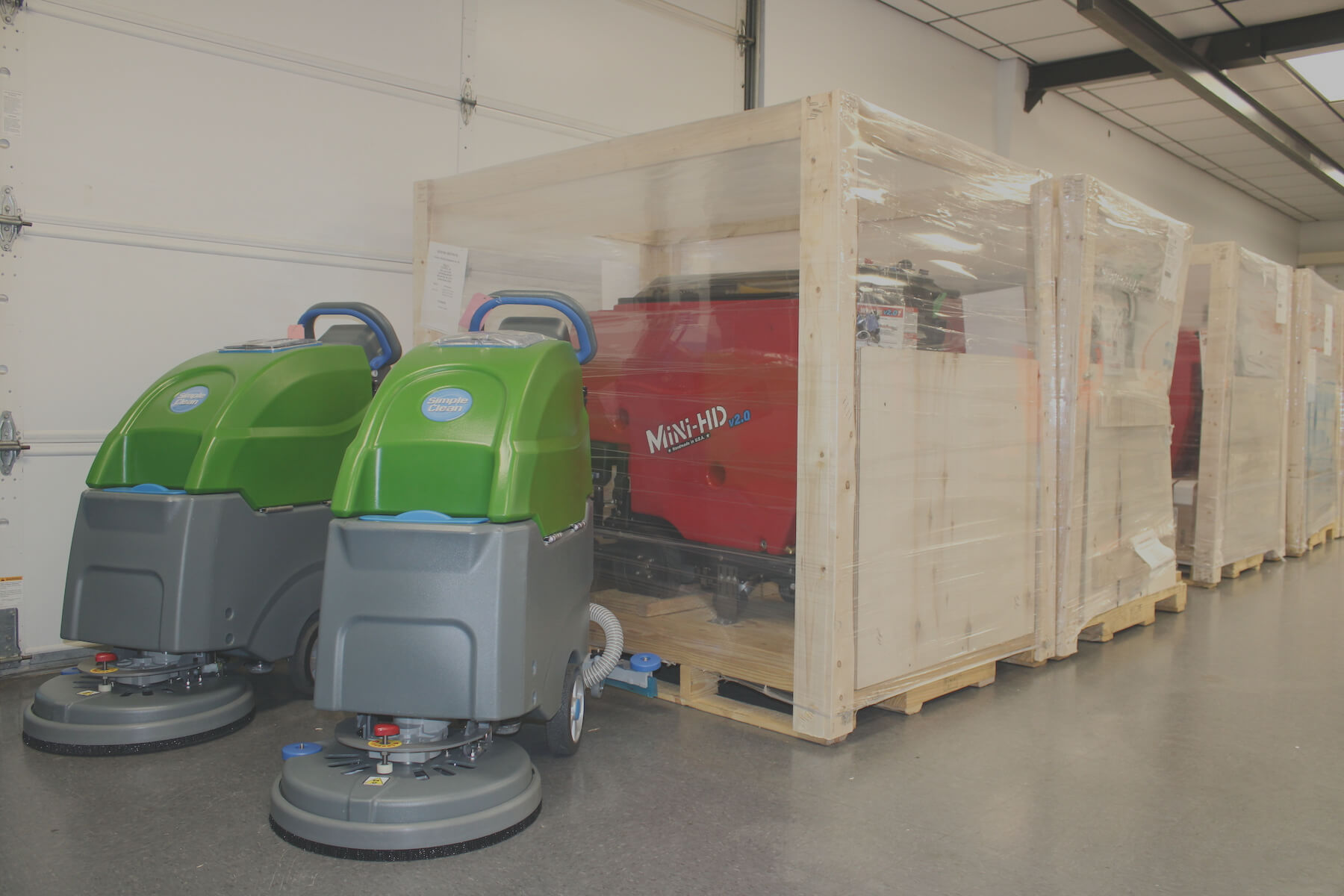 walk behind floor scrubbers lined up in warehouse ready to ship